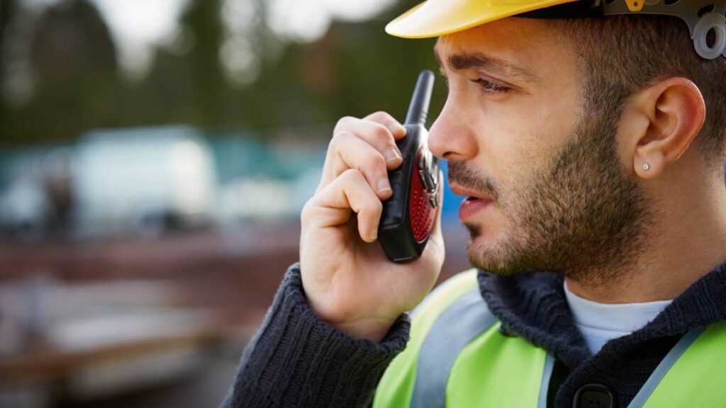 construction working talking on a two way radios